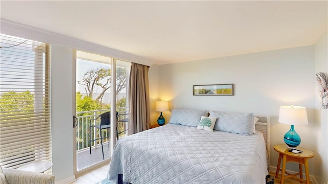 1175 N Beachview Dr Unit 389, Jekyll Island, GA 31527 - bedroom with baseboards, access to exterior, and wood finished floors