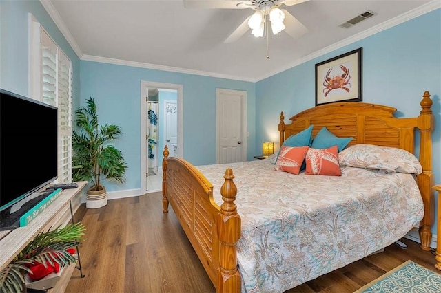 bedroom featuring wood finished floors, crown molding, baseboards, and ceiling fan