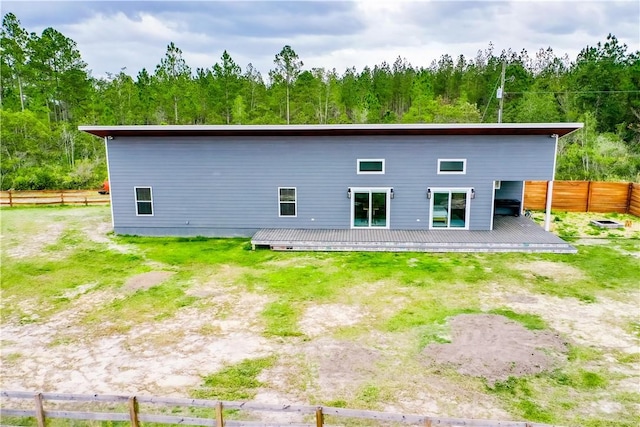 3935 Memorial Dr, Waycross, GA 31503 - back of property with a deck, fence, and a view of trees