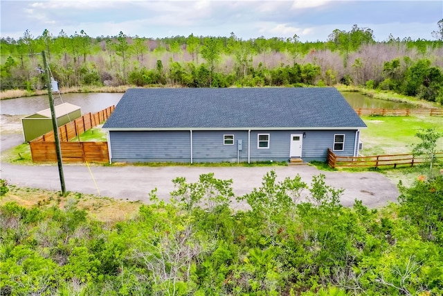 3935 Memorial Dr, Waycross, GA 31503 - exterior space featuring a water view, fence, and roof with shingles
