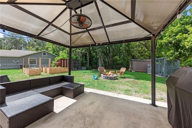 view of patio with an outdoor living space with a fire pit, an outdoor structure, a grill, and fence private yard
