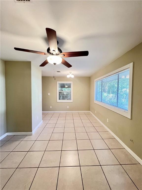 1920 Washington St, Brunswick, GA 31520 - empty room featuring a ceiling fan and light tile patterned flooring