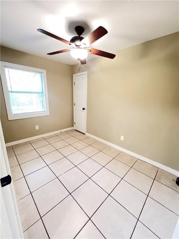 1920 Washington St, Brunswick, GA 31520 - empty room with light tile patterned floors and a ceiling fan