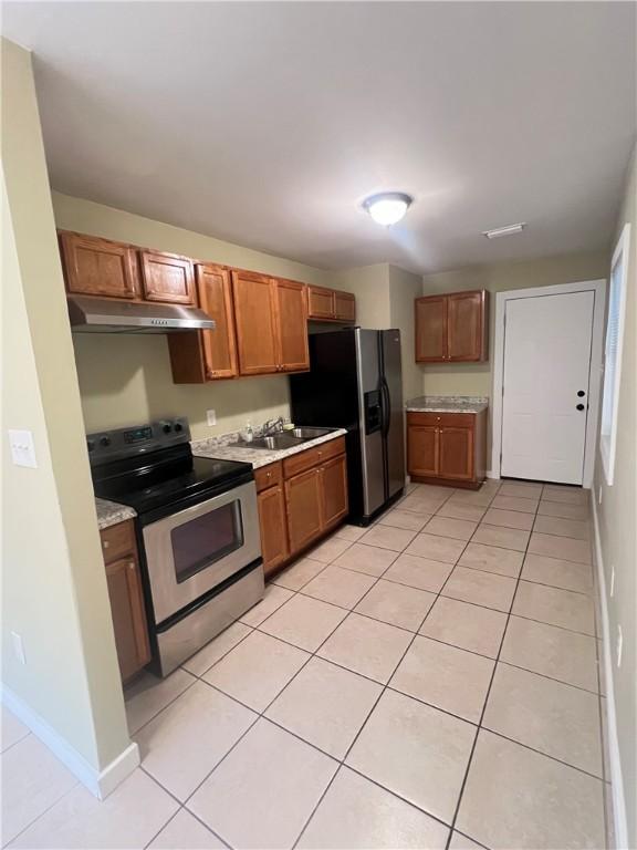 1920 Washington St, Brunswick, GA 31520 - kitchen with stainless steel appliances, light countertops, a sink, and light tile patterned floors