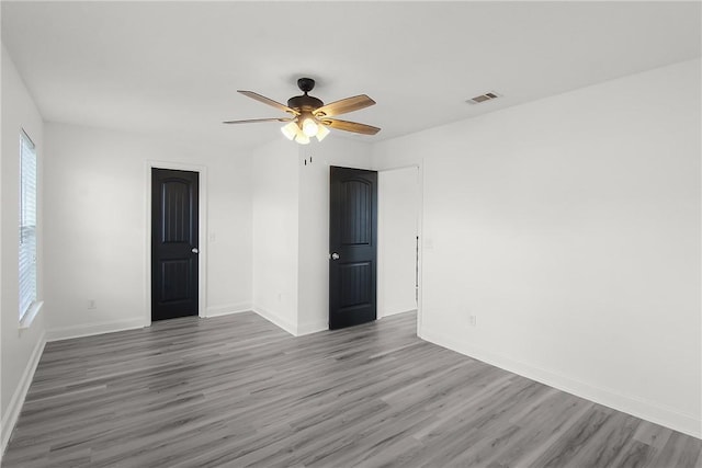 spare room with ceiling fan and hardwood / wood-style floors