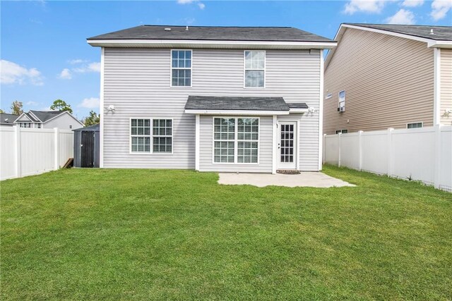 rear view of property with a patio and a lawn