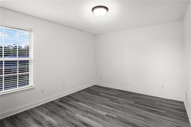 spare room featuring dark hardwood / wood-style floors