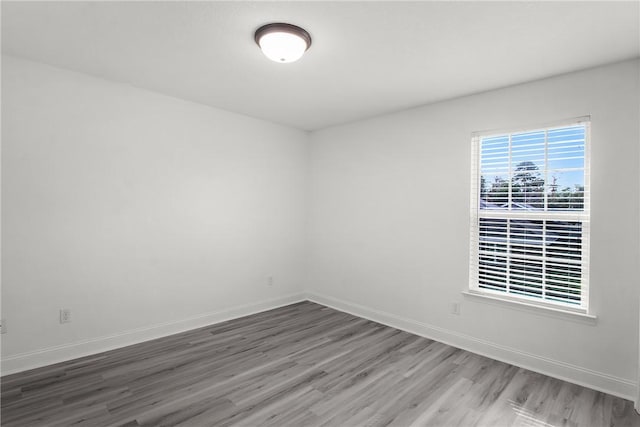 unfurnished room with hardwood / wood-style floors