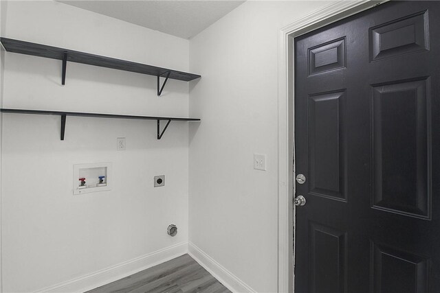 laundry room featuring electric dryer hookup, hookup for a washing machine, and dark wood-type flooring