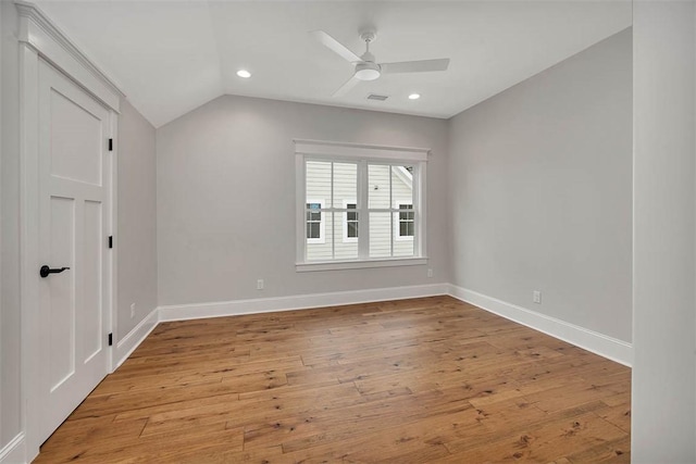 interior space with lofted ceiling, recessed lighting, light wood-style flooring, a ceiling fan, and baseboards