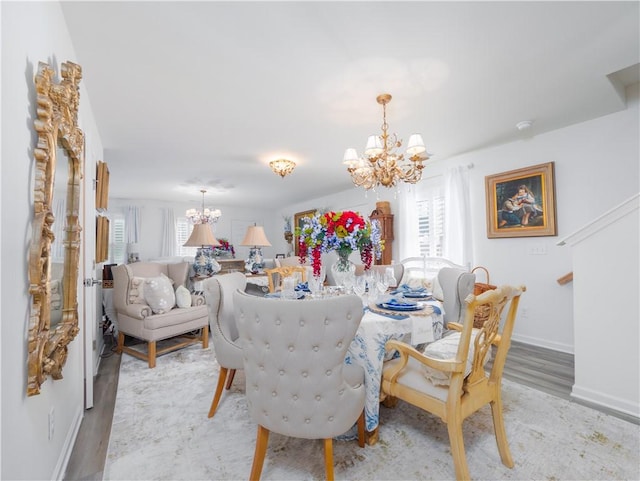 138 Mohr Club Dr, Darien, GA 31305 - dining room with a chandelier, light wood-type flooring, and baseboards
