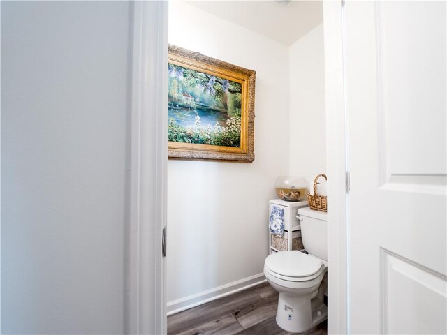 138 Mohr Club Dr, Darien, GA 31305 - bathroom featuring wood finished floors, baseboards, and toilet