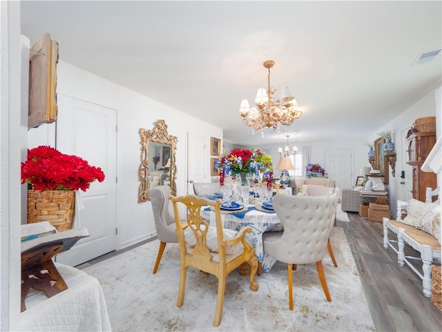 138 Mohr Club Dr, Darien, GA 31305 - dining area featuring a chandelier and wood finished floors