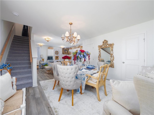 138 Mohr Club Dr, Darien, GA 31305 - dining space with stairway, a chandelier, and wood finished floors