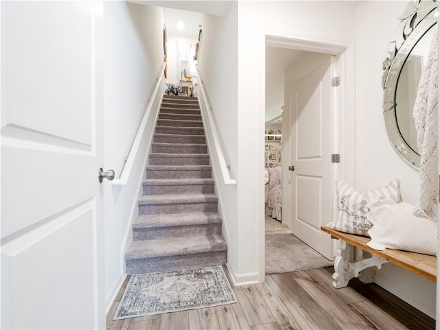 138 Mohr Club Dr, Darien, GA 31305 - staircase with wood finished floors and baseboards