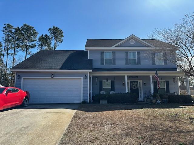 front facade with a garage and a porch