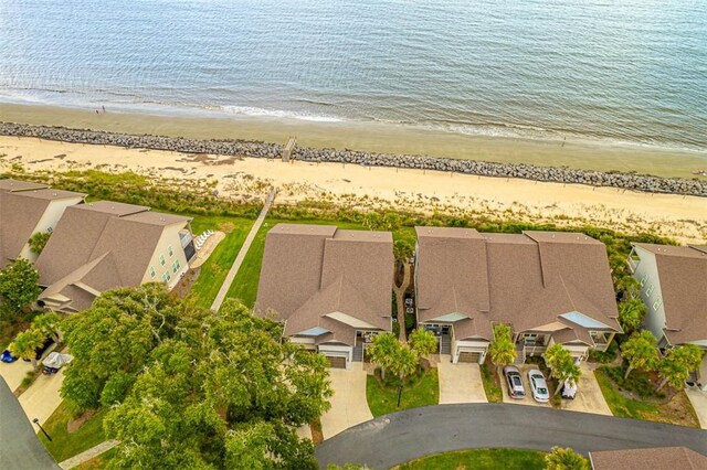 birds eye view of property featuring a view of the beach and a water view