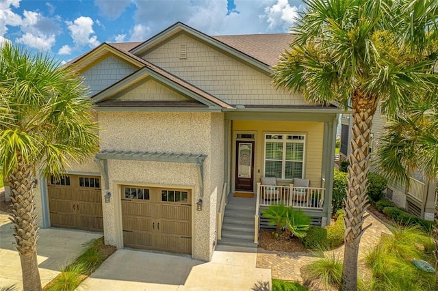 view of front of property with a porch and a garage