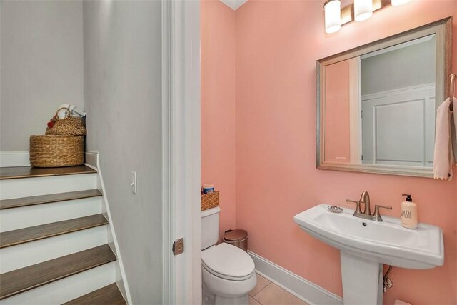 bathroom with tile patterned floors, toilet, and sink