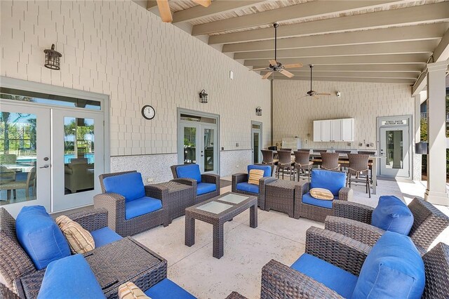 view of patio / terrace with an outdoor living space, ceiling fan, and french doors