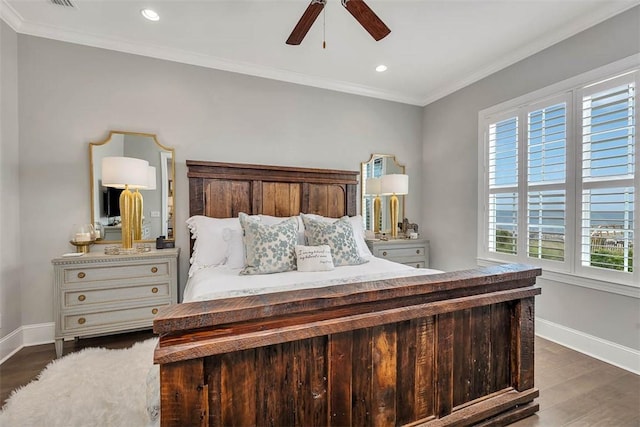 bedroom with ceiling fan, dark hardwood / wood-style floors, and ornamental molding