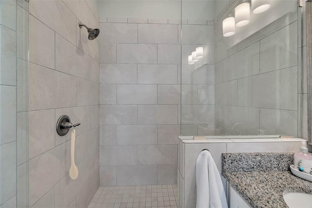 bathroom featuring vanity and tiled shower