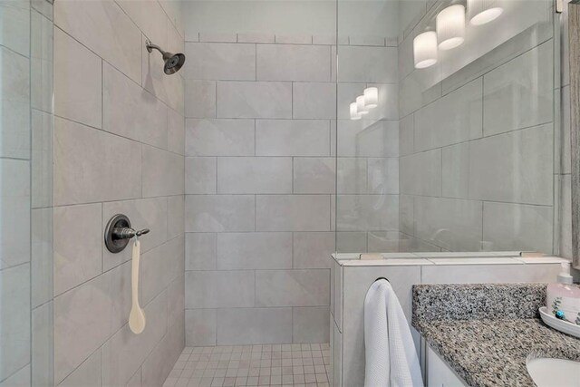 bathroom featuring vanity and tiled shower