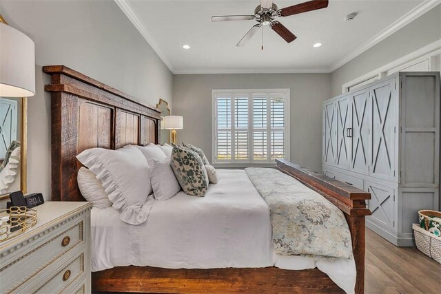 bedroom with ceiling fan, crown molding, and wood-type flooring