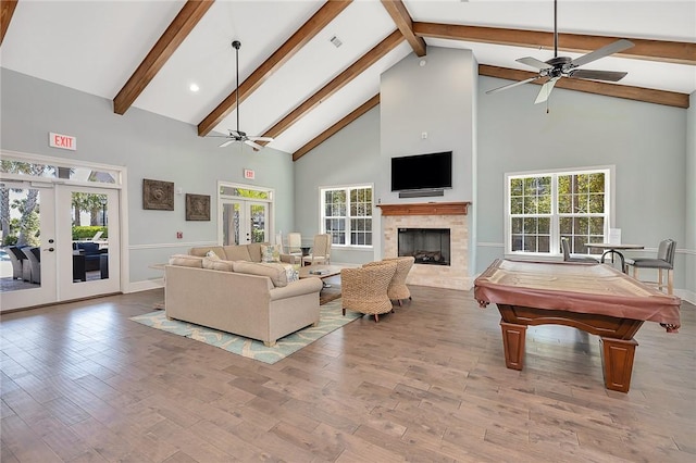 living room with high vaulted ceiling, light wood-type flooring, billiards, and french doors