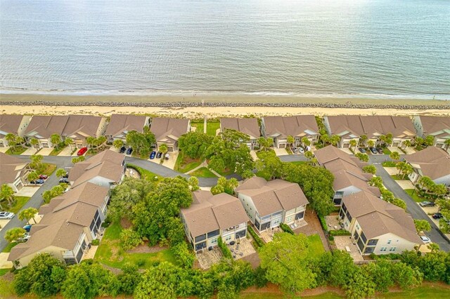 drone / aerial view featuring a water view and a beach view