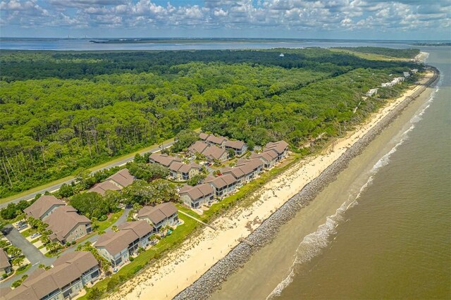 drone / aerial view with a water view and a beach view