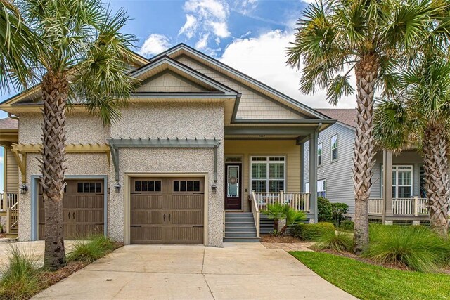 view of front of property with a porch and a garage