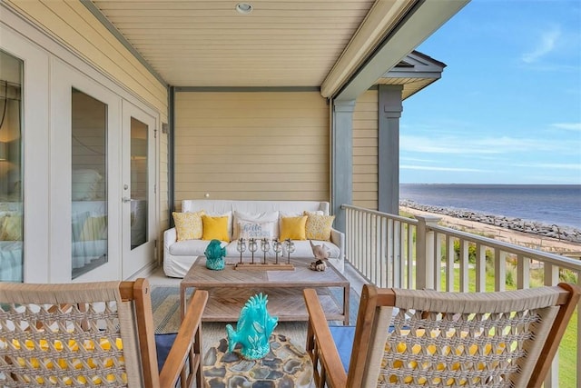 balcony featuring a water view and a view of the beach