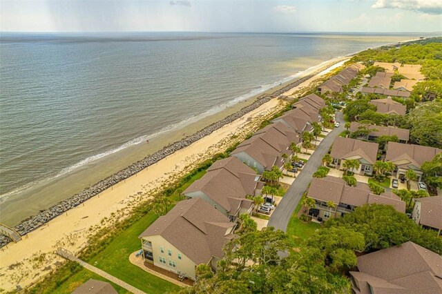 birds eye view of property with a water view and a beach view