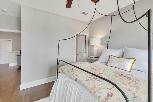 bedroom with dark hardwood / wood-style floors and ceiling fan