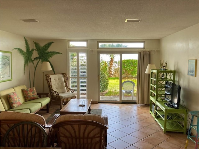 interior space featuring light tile patterned floors and a textured ceiling