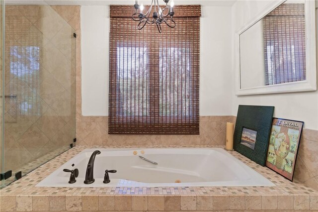 105 Driftwood Pl, Saint Simons Island, GA 31522 - bathroom with a chandelier, a jetted tub, and a shower stall
