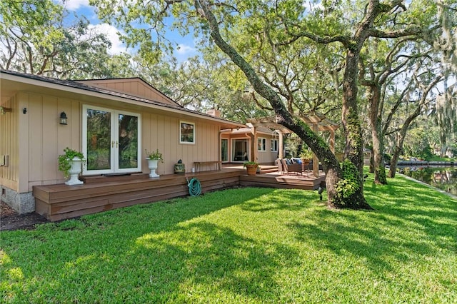 105 Driftwood Pl, Saint Simons Island, GA 31522 - rear view of property with a pergola, a wooden deck, french doors, board and batten siding, and a yard