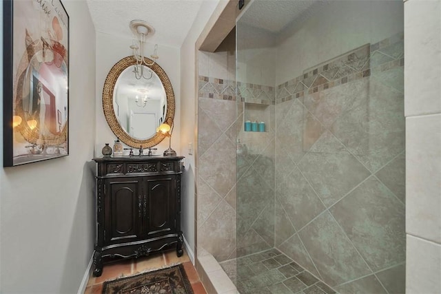 105 Driftwood Pl, Saint Simons Island, GA 31522 - bathroom featuring vanity, a tile shower, and a textured ceiling