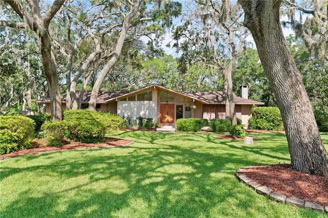105 Driftwood Pl, Saint Simons Island, GA 31522 - view of front of property with a chimney and a front lawn