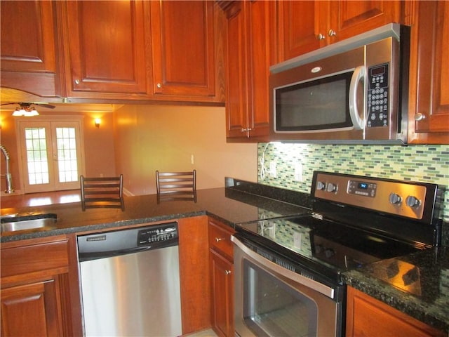 kitchen featuring tasteful backsplash, ceiling fan, a sink, and stainless steel appliances