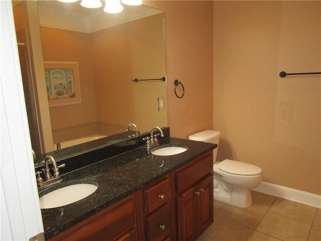 full bath featuring tile patterned floors, a sink, toilet, and baseboards