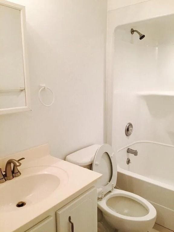 full bathroom with shower / washtub combination, vanity, and toilet