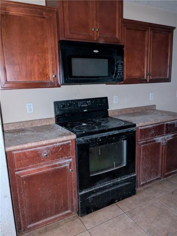 kitchen featuring light tile patterned floors and black appliances