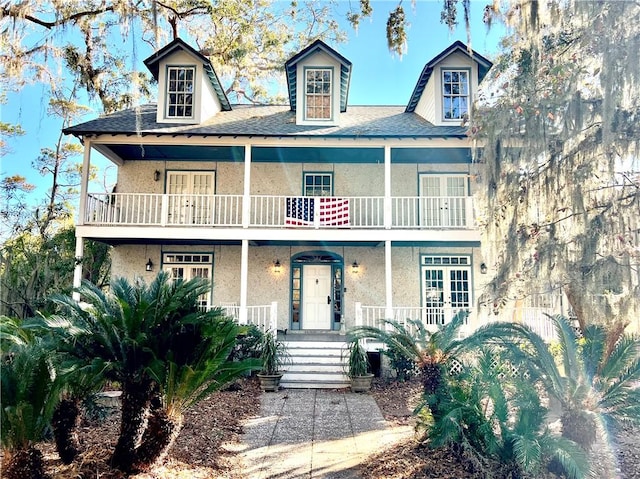 view of front of property featuring a porch and a balcony