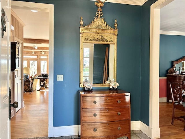 corridor featuring light hardwood / wood-style floors, crown molding, and french doors