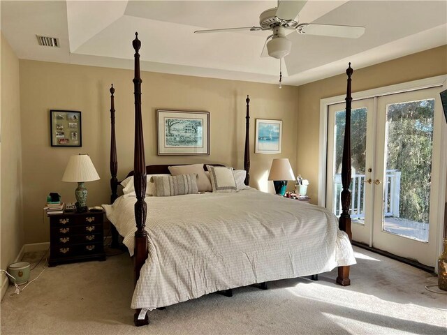 carpeted bedroom with a raised ceiling, ceiling fan, access to exterior, and french doors