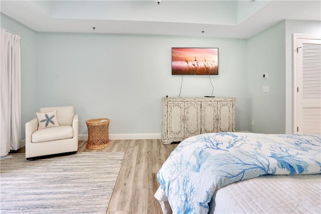 bedroom featuring baseboards and wood finished floors