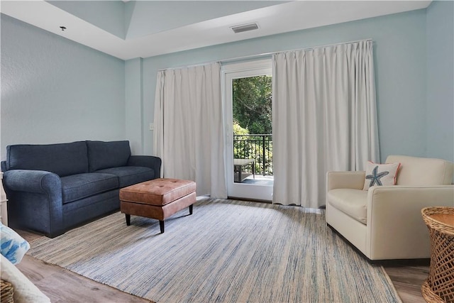 living room with wood finished floors and visible vents