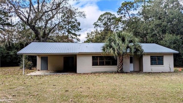 843 Scranton Rd, Brunswick, GA 31525 - view of front of home with concrete block siding, a front lawn, and metal roof